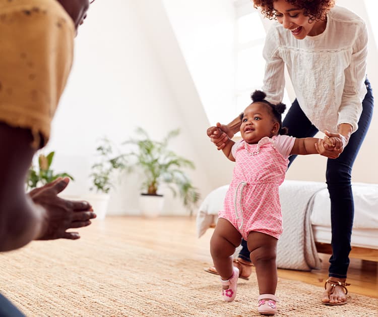 Dad helping toddler walk