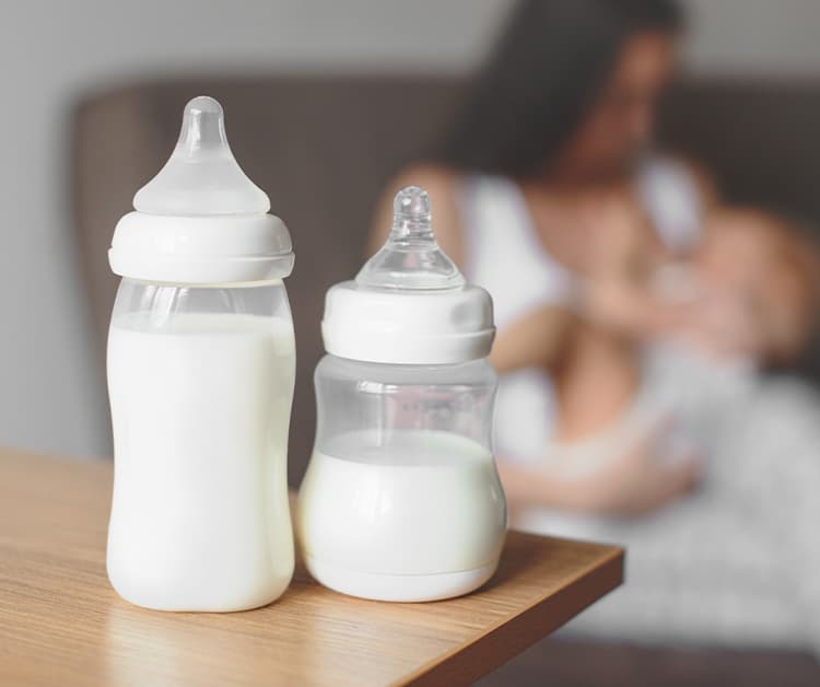 Baby bottles filled with milk on a table