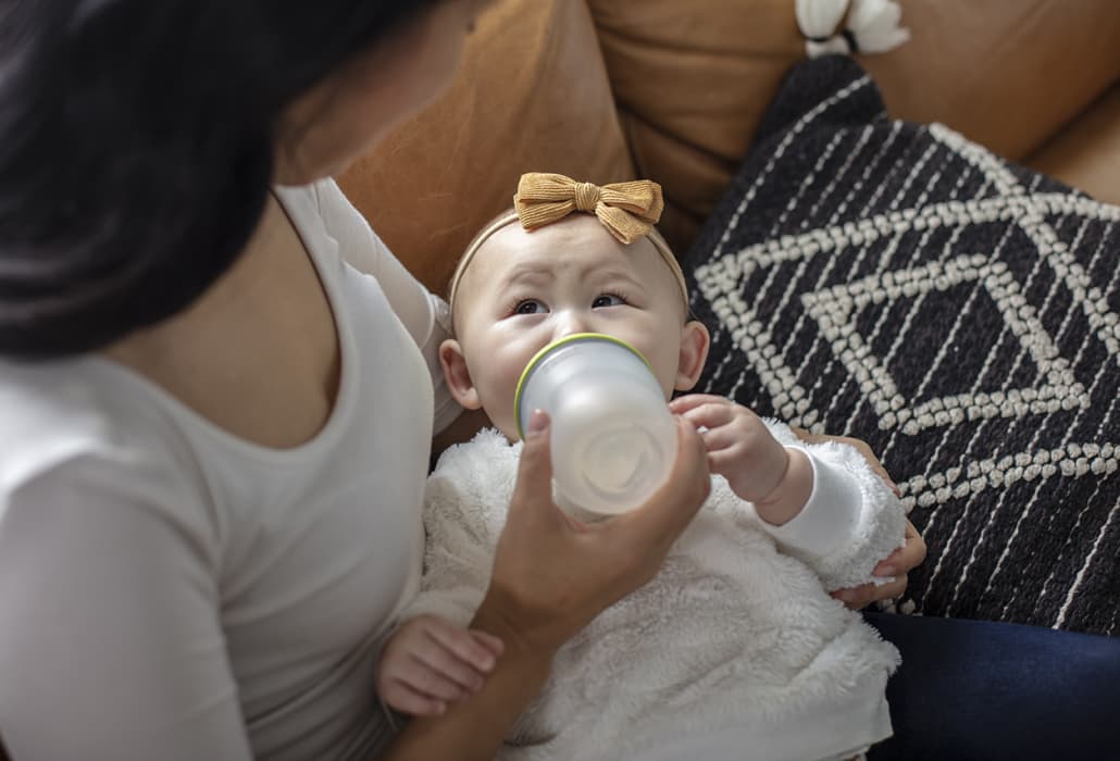 Mom feeding baby a bottle