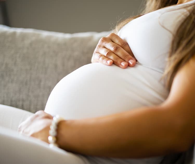Pregnant woman holding her baby bump