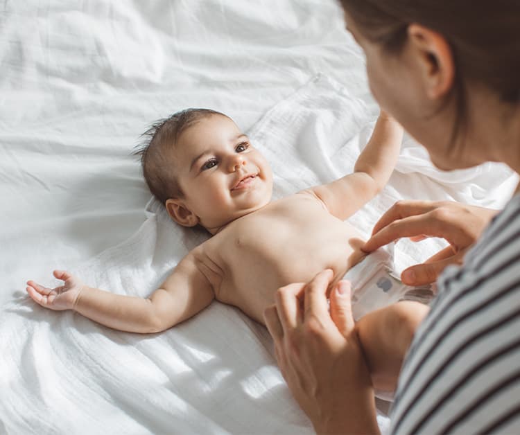 Mom changing her baby diaper