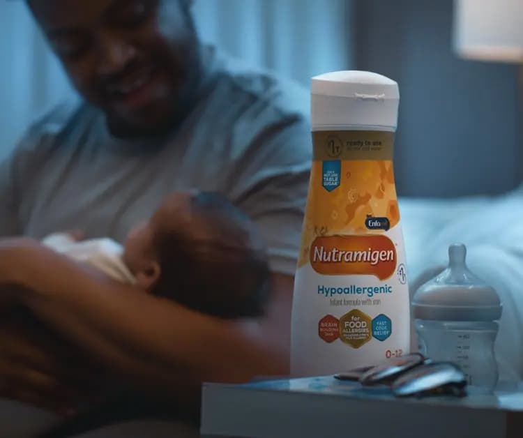 Dad with his baby and Nutramigen® Hypoallergenic Infant Formula