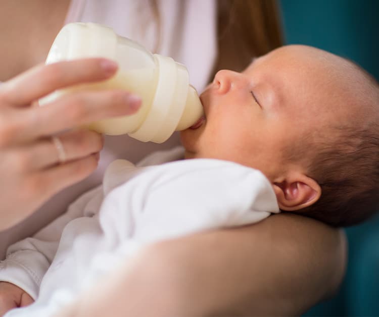 Parent bottle feeding baby
