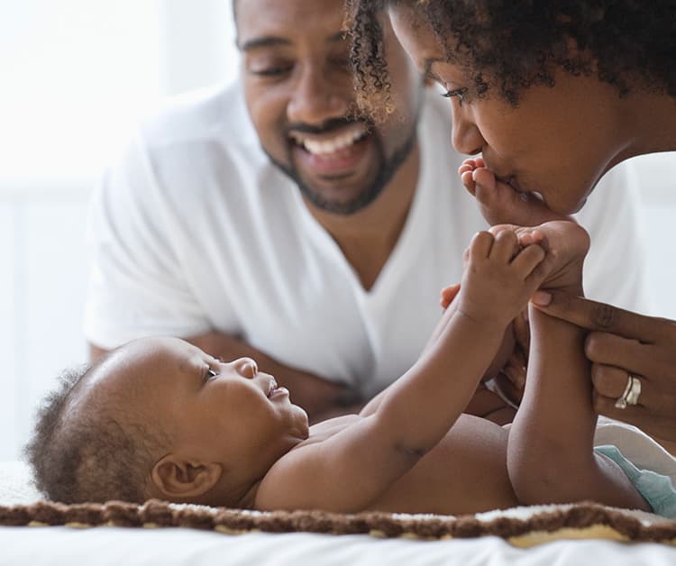 Parent massaging baby's tummy