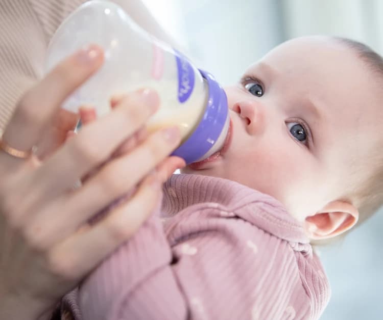 Mom feeding baby a bottle