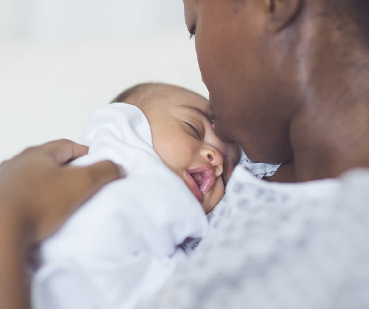 Mom loving on newborn baby