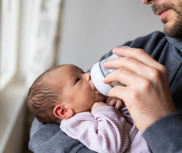 Dad feeding his baby