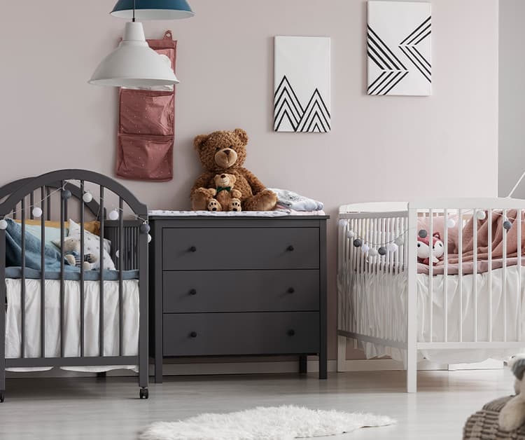 Two cribs in a nursery