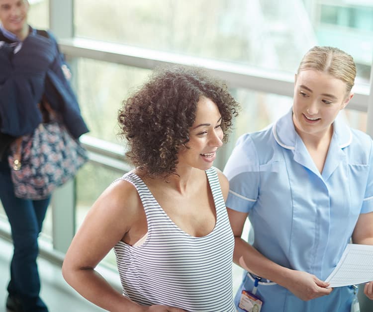 Pregnant mom touring the maternity wing with healthcare provider