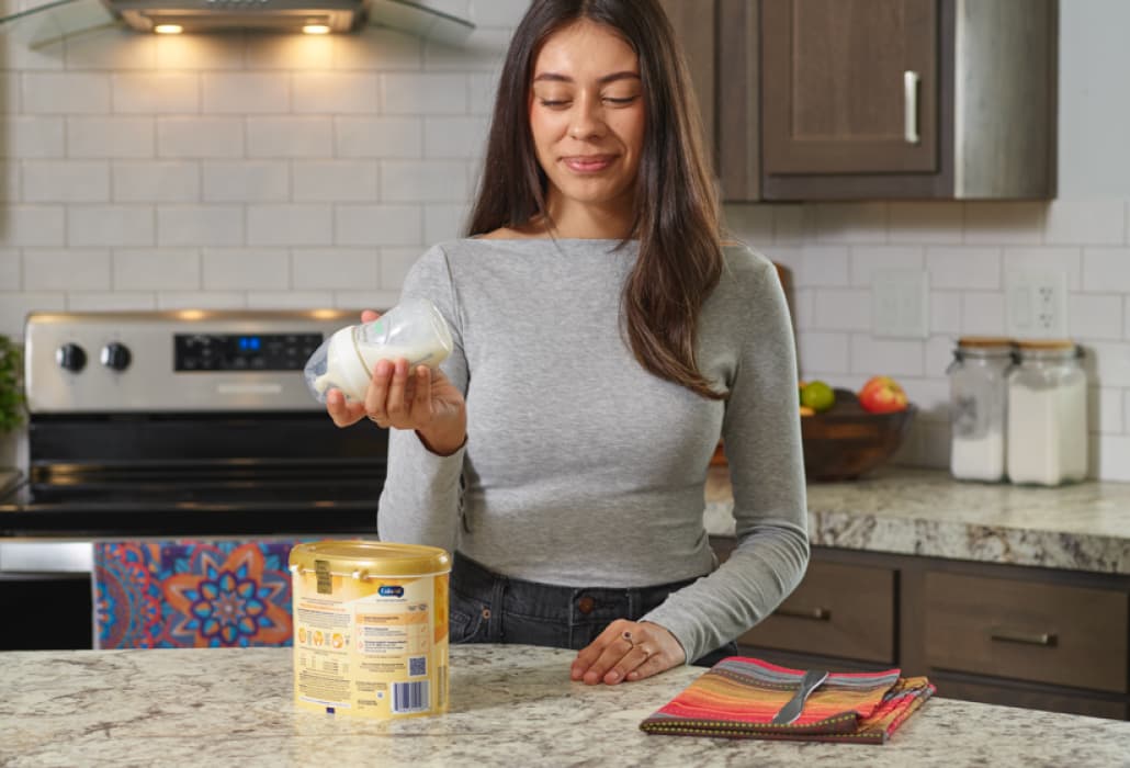 Mom shaking a bottle of formula