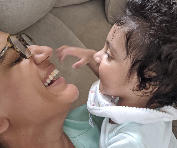 Mom holding her baby and smiling