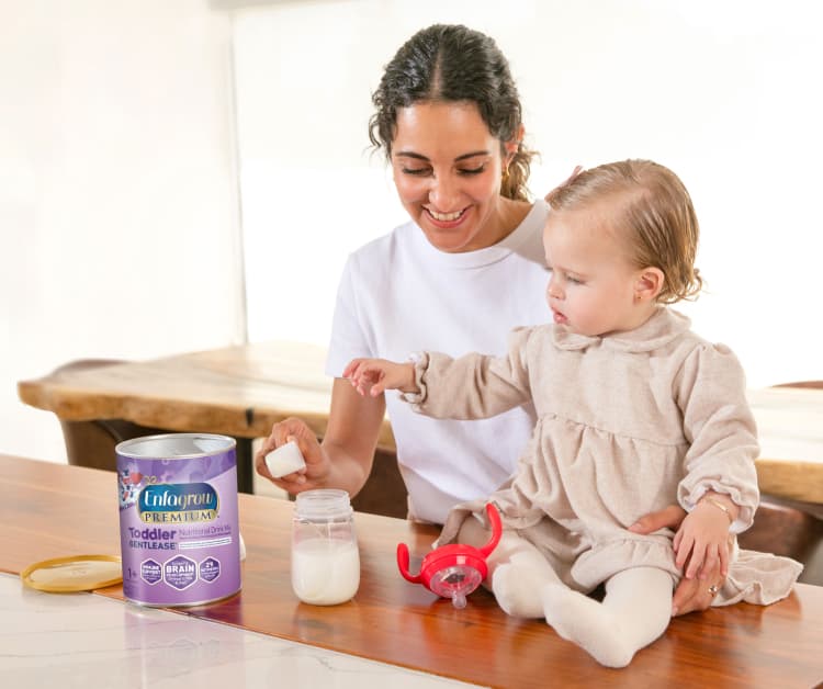 Mom preparing Enfagrow for toddler