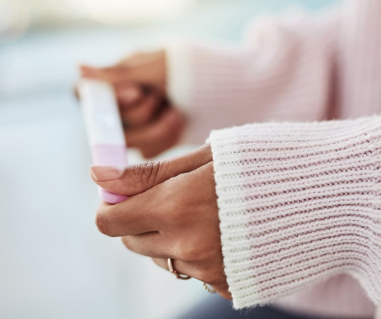 Woman holding pregnancy test