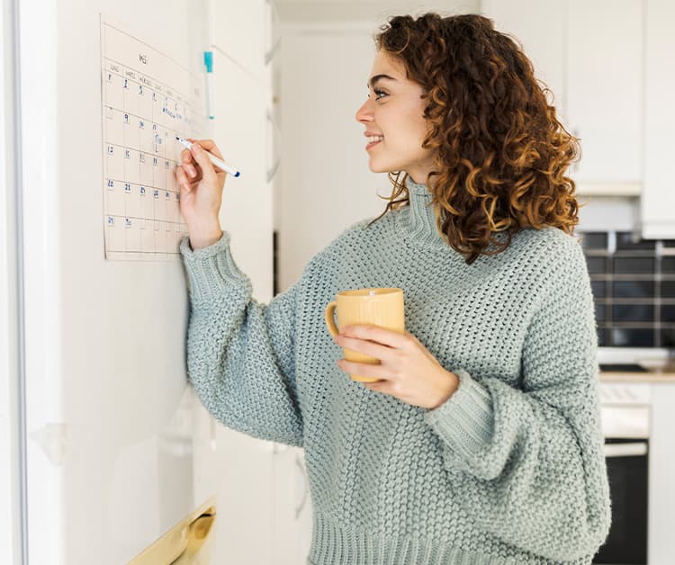 Pregnant woman marking calendar
