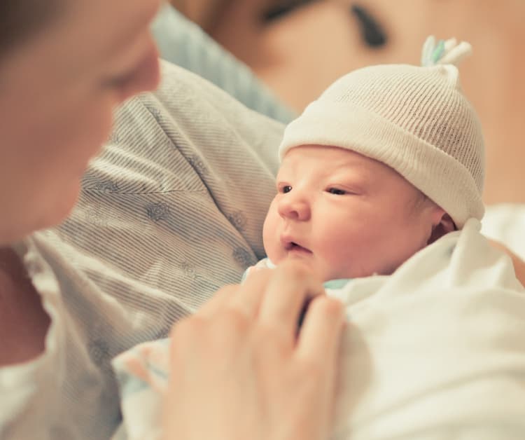 Parent holding a premature baby